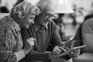 Senior couple buying life insurance online
